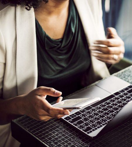 Woman using digital devices at a cafe